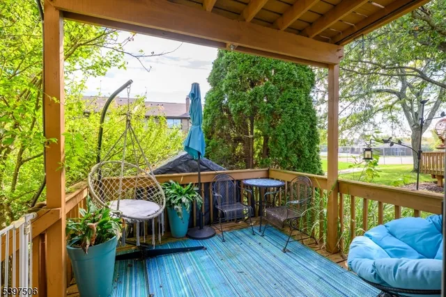 a view of a chairs and table in patio with a yard