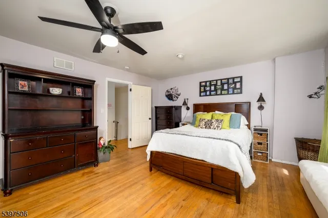 a bedroom with a bed a dresser and a book shelf