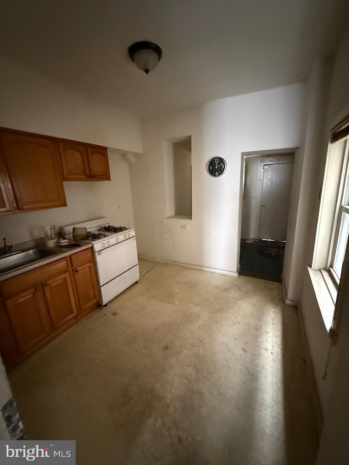 1903 Point Breeze Avenue Philadelphia, PA 19145 - Photo 5 of 9 a view of kitchen and empty room with wooden floor