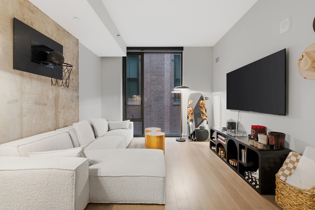 55 Lagrange Street, Unit 309 Boston, MA 02111 - Photo 1 of 20 a living room with furniture and a flat screen tv