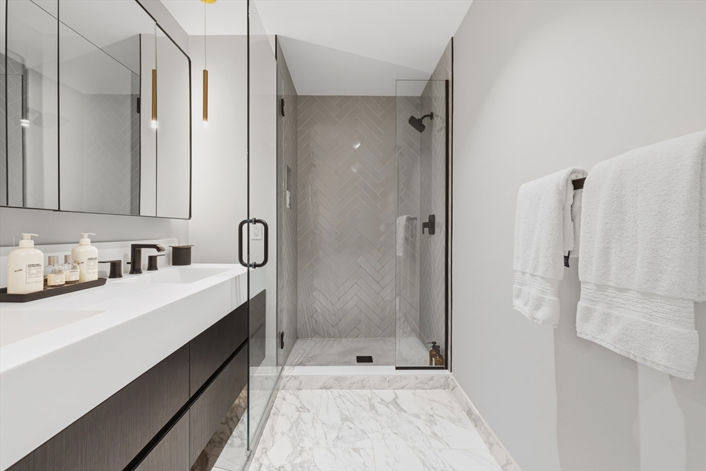 55 Lagrange Street, Unit 309 Boston, MA 02111 - Photo 13 of 20 a bathroom with a sink double vanity and shower
