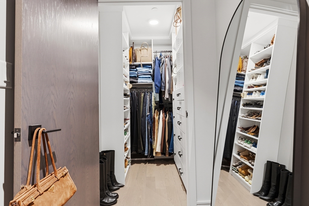 55 Lagrange Street, Unit 309 Boston, MA 02111 - Photo 14 of 20 a view of a hallway with wooden floor and staircase