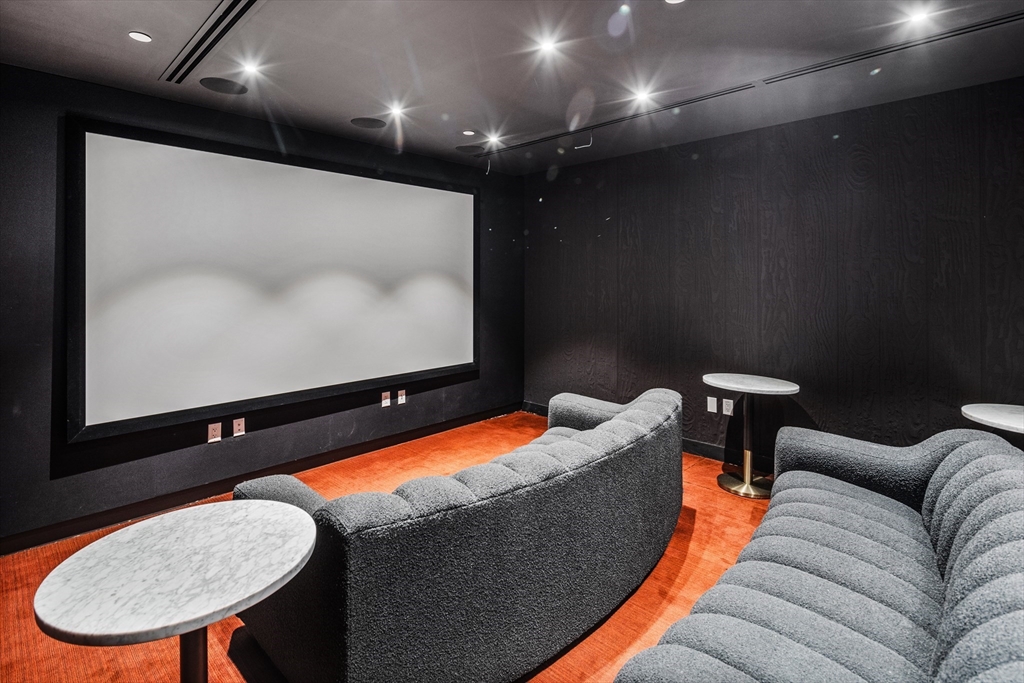 55 Lagrange Street, Unit 309 Boston, MA 02111 - Photo 19 of 20 a living room with furniture pool and a projector screen