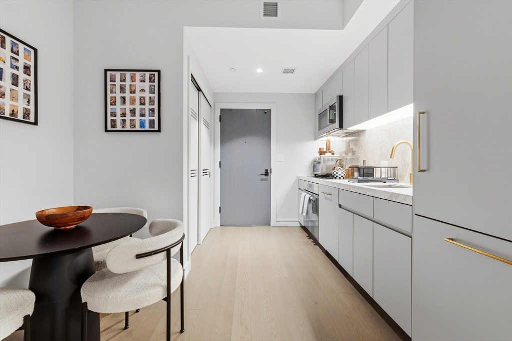 55 Lagrange Street, Unit 309 Boston, MA 02111 - Photo 9 of 20 a kitchen with furniture and appliances