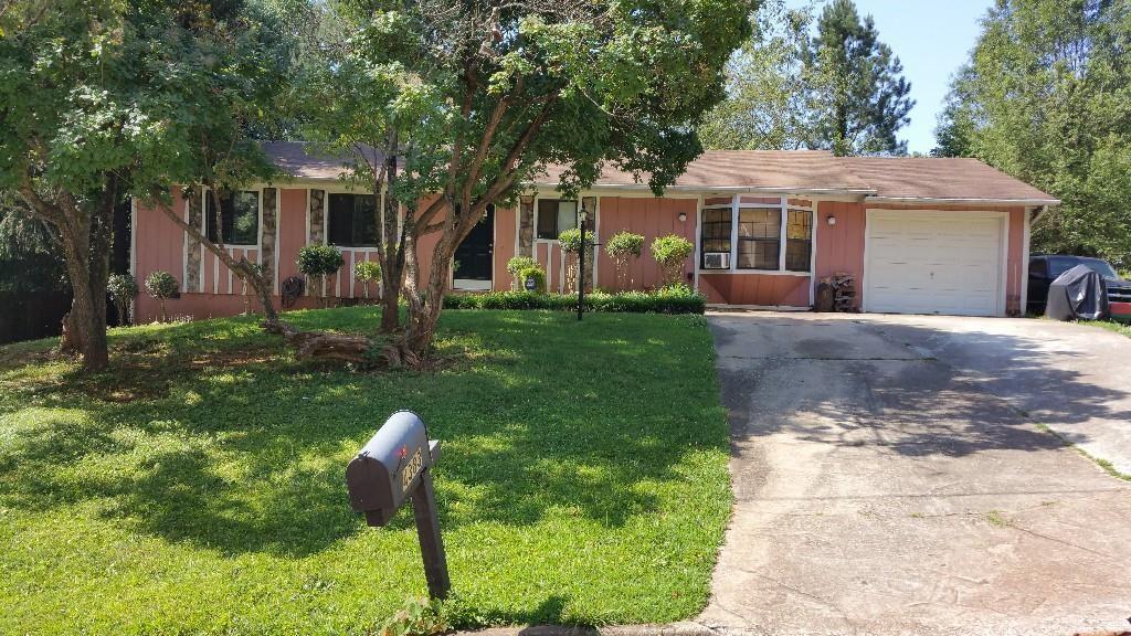 4383 Glen Raven Court Decatur, GA 30035 - Photo 1 of 1 a front view of a house with a yard table and chairs