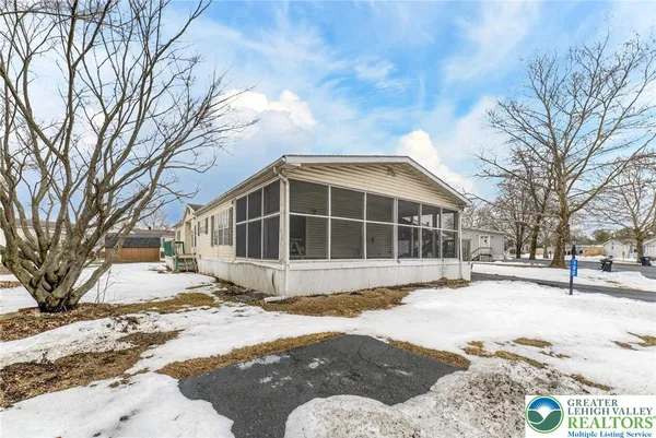 a view of a house with a yard covered in snow