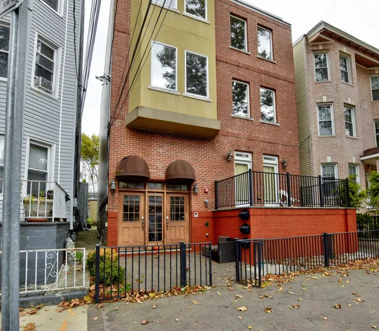 a front view of a brick building with many windows