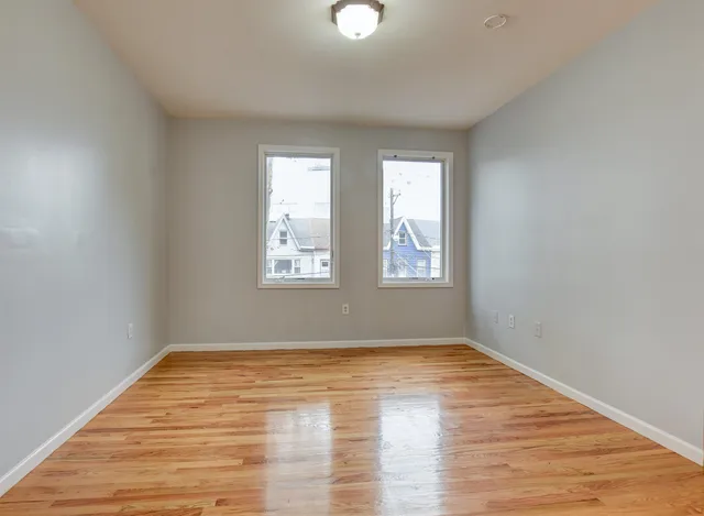 wooden floor in an empty room with a window