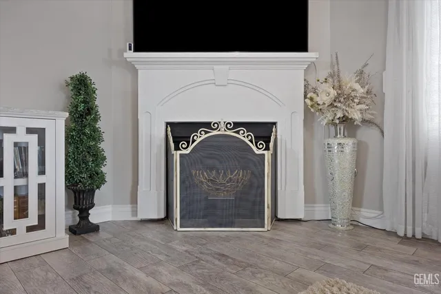 a kitchen with granite countertop white cabinets sink and stainless steel appliances