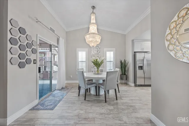 a kitchen that has a lot of cabinets in it and wooden floors