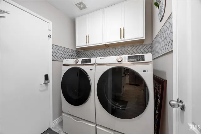 a living room with a couch and a chandelier