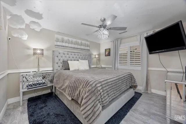 a bedroom with a bed and a chandelier