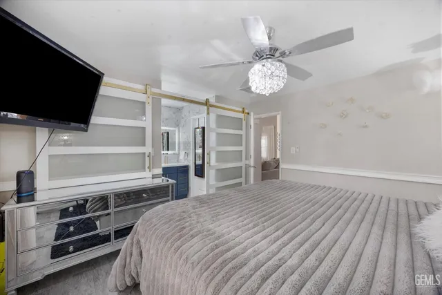 a bedroom with a bed and a chandelier