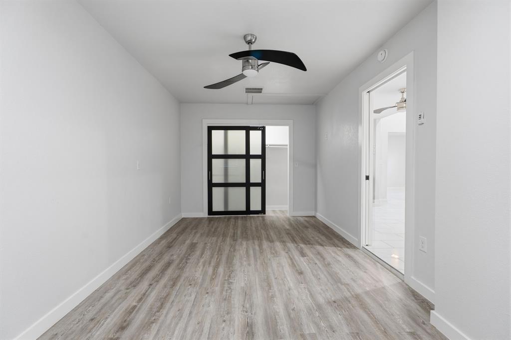 3721 Smartt Street Rowlett, TX 75088 - Photo 17 of 27 wooden floor in an empty room with a window