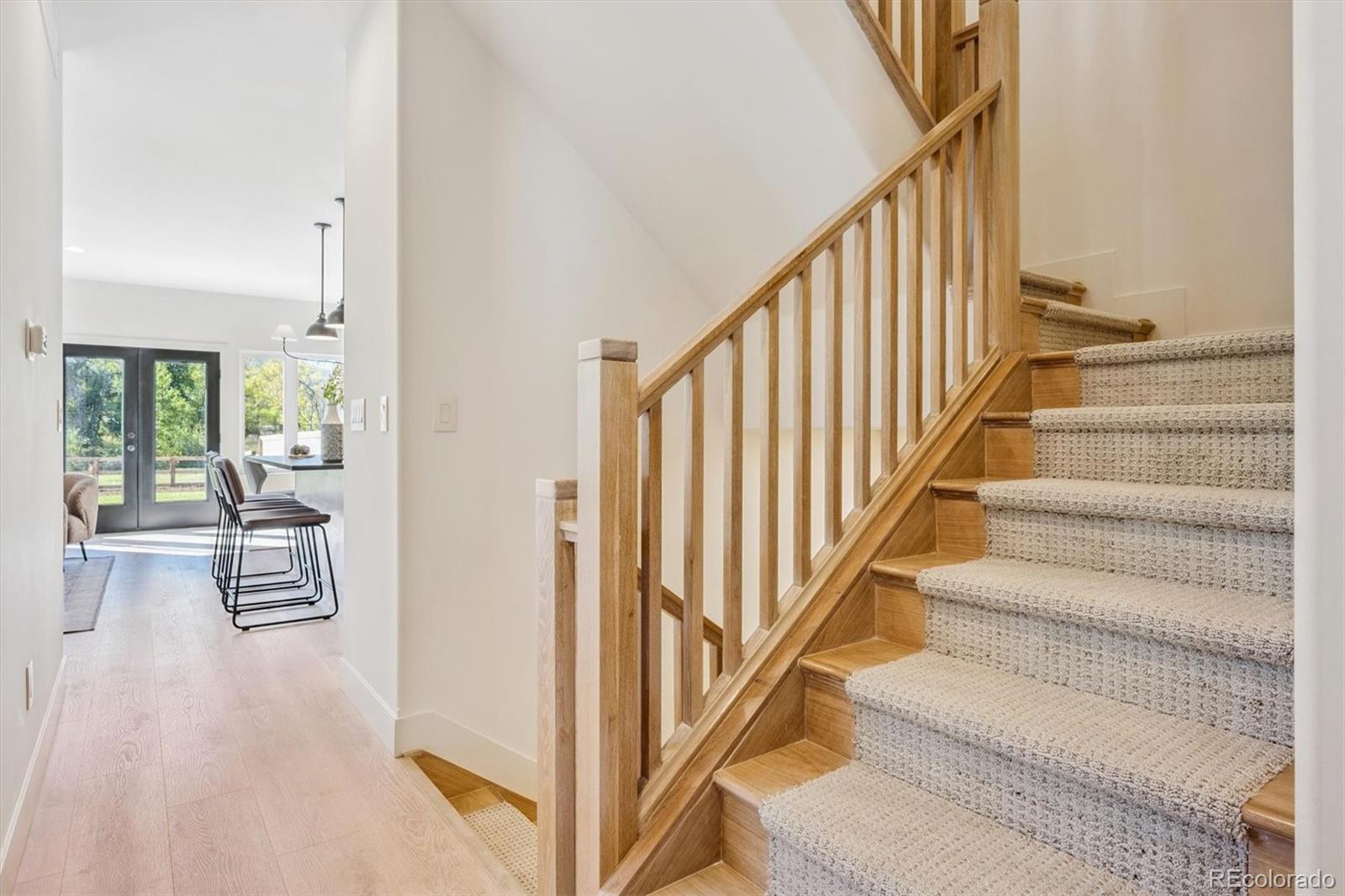 16170 Mt Vernon Road Golden, CO 80401 - Photo 15 of 44 a view of staircase with lots of frames on wall and windows