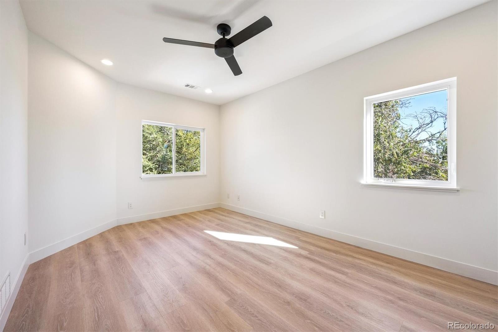 16170 Mt Vernon Road Golden, CO 80401 - Photo 25 of 44 a view of empty room with wooden floor and window