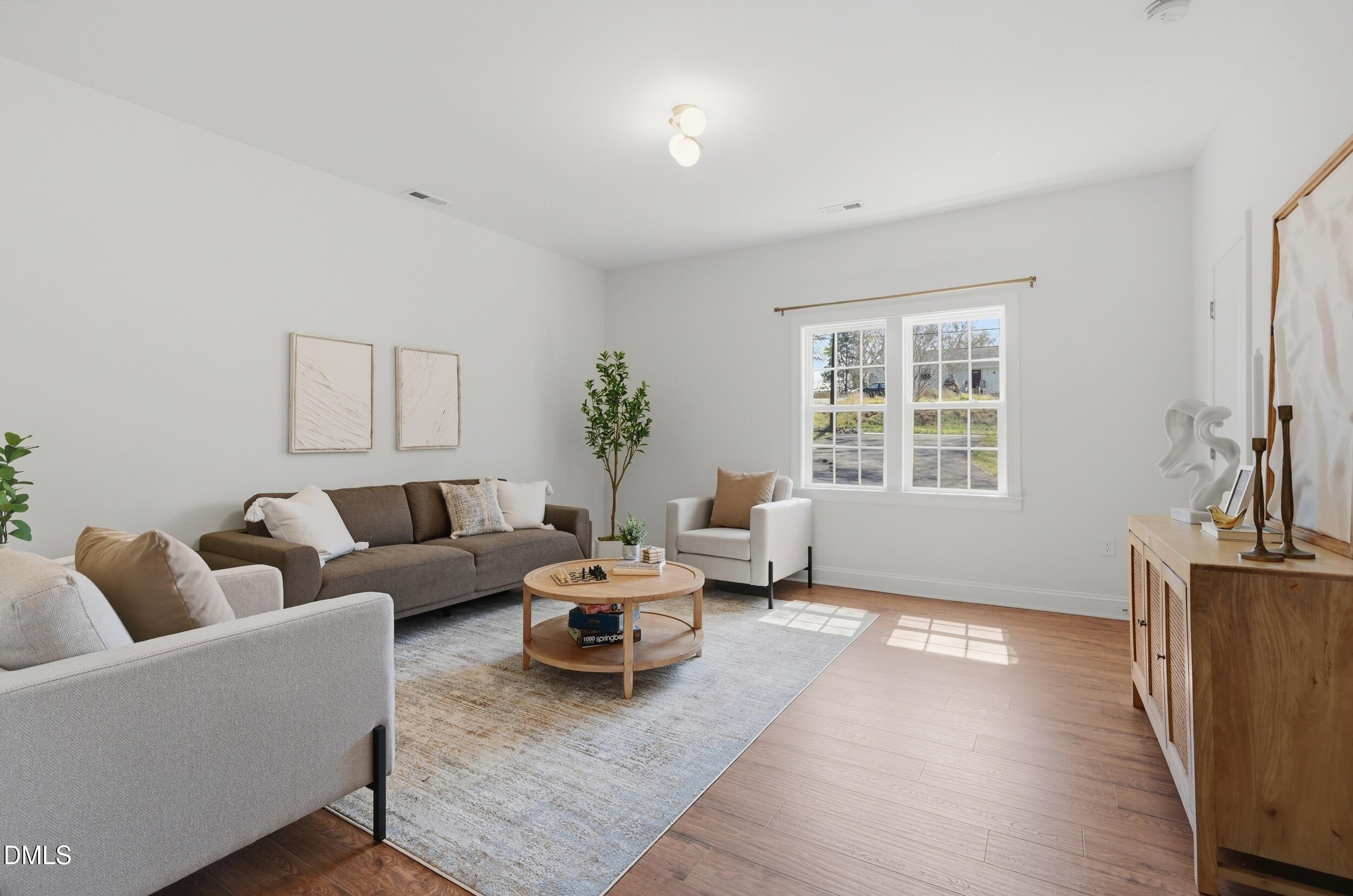 2301 Milburnie Road Raleigh, NC 27610 - Photo 8 of 23 a living room with furniture and a window