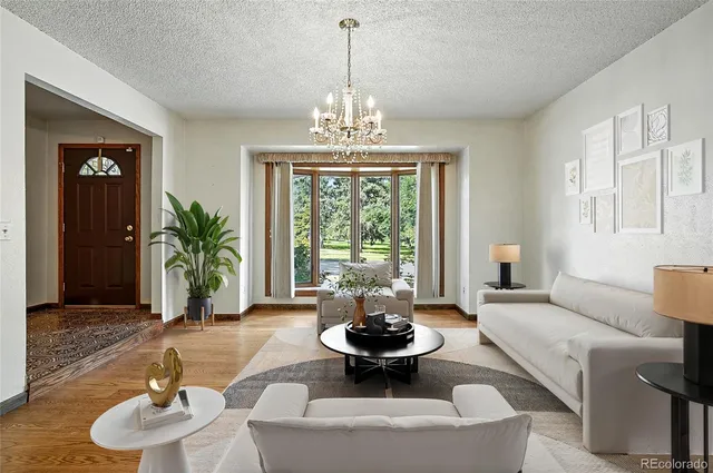 a living room with furniture and a chandelier