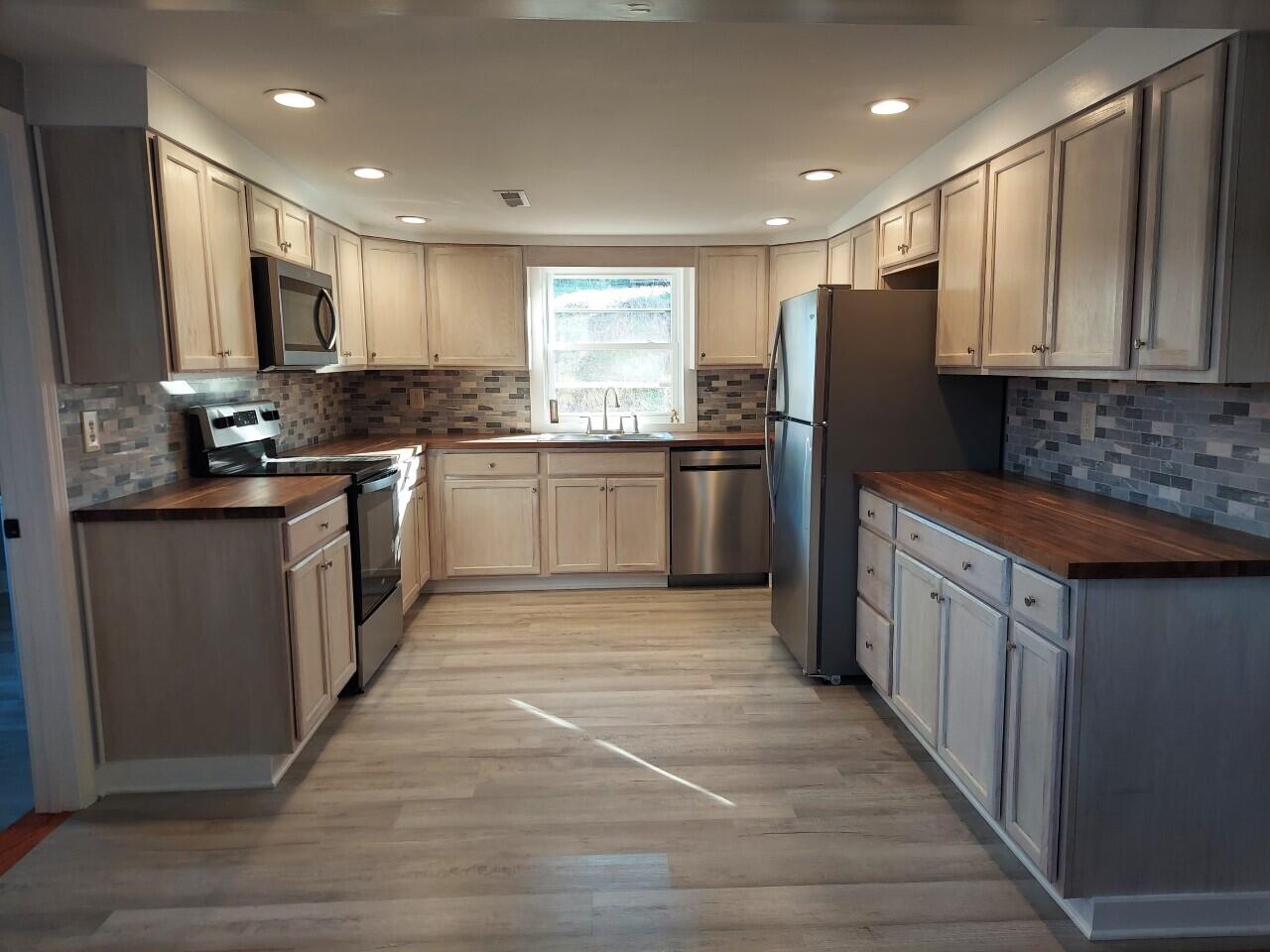 2812 Webster Road Blue Ridge, VA 24064 - Photo 5 of 38 a kitchen with stainless steel appliances granite countertop refrigerator a stove top oven a sink and dishwasher