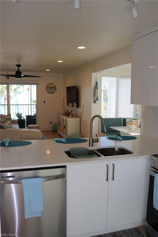 2235 San Marco Road, Unit 5204 Marco Island, FL 34145 - Photo 12 of 34 Modern kitchen island featuring a double stainless steel sink with a gooseneck faucet