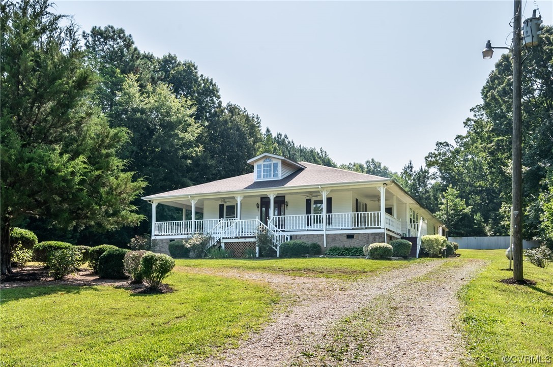 a view of a house with a big yard and large trees