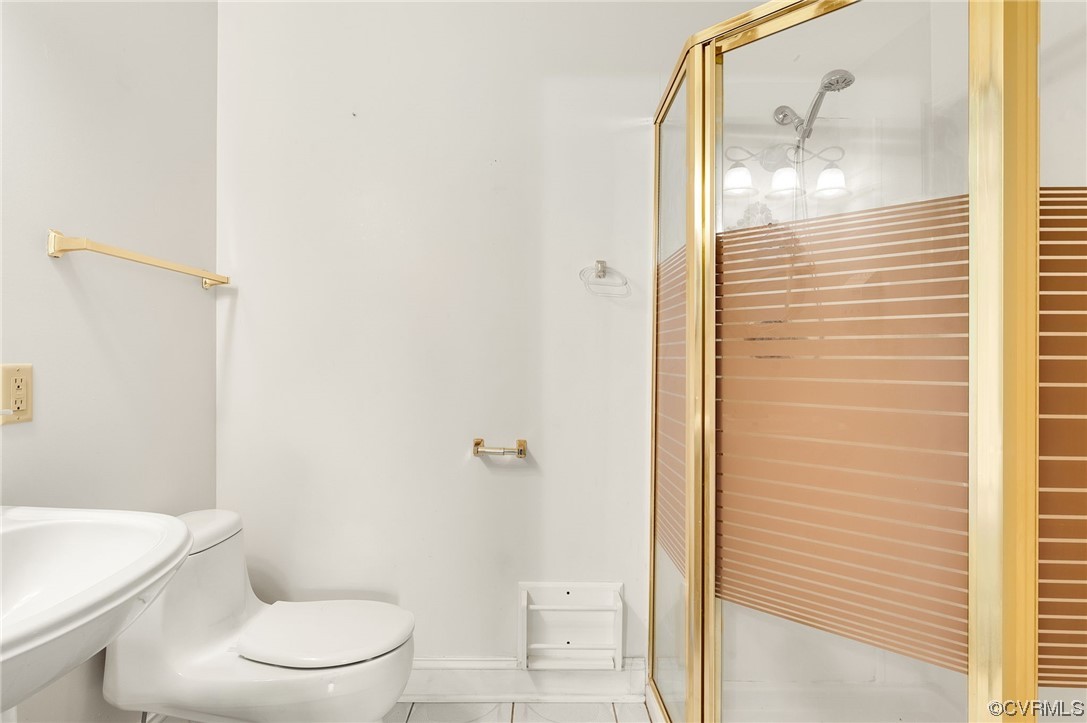 5158 Boydton Plank Road Brodnax, VA 23920 - Photo 16 of 43 a white toilet sitting next to a bathroom sink