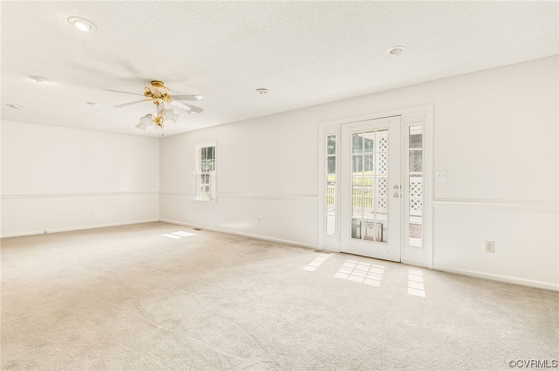 5158 Boydton Plank Road Brodnax, VA 23920 - Photo 19 of 43 an empty room with windows and chandelier fan