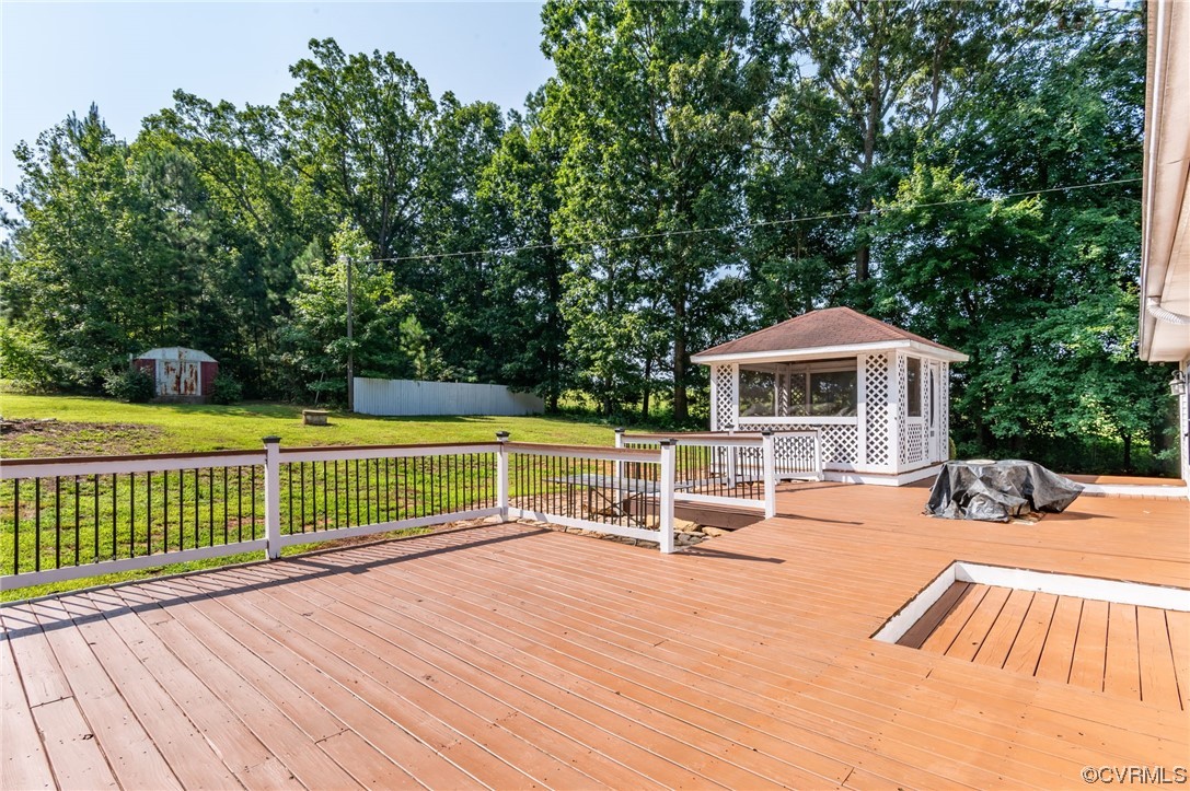 5158 Boydton Plank Road Brodnax, VA 23920 - Photo 26 of 43 a view of house with deck outdoor seating and trees in the background
