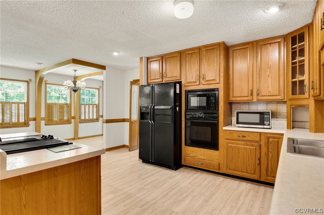 5158 Boydton Plank Road Brodnax, VA 23920 - Photo 10 of 43 a kitchen with stainless steel appliances granite countertop a refrigerator a stove and a sink with large window