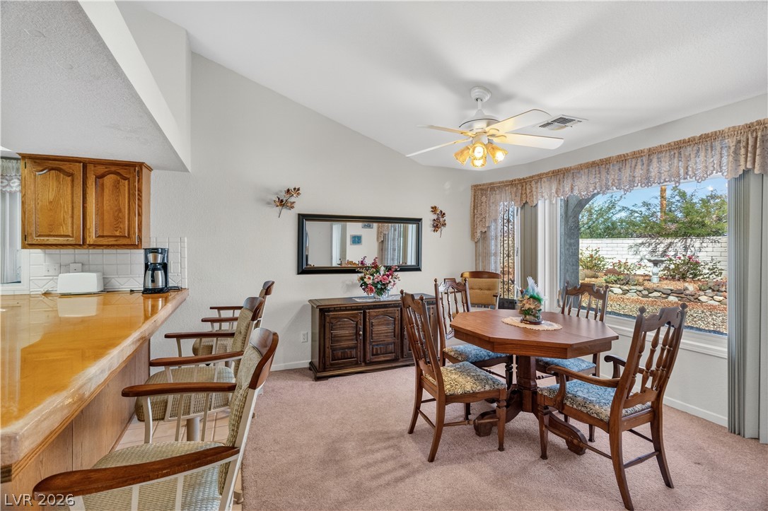 2055 Cholla Way Laughlin, NV 89029 - Photo 18 of 87 Natural light floods this dining area, complete with a breakfast bar and backyard views.