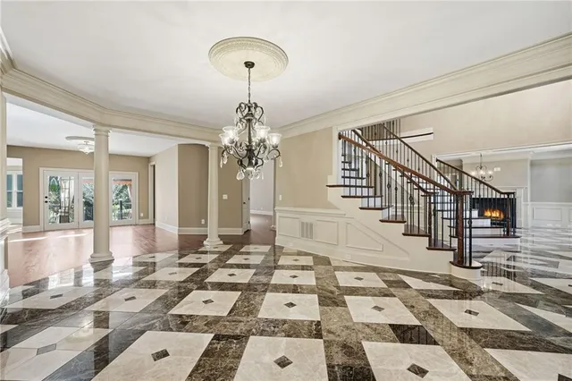 an empty room with closet and a chandelier fan
