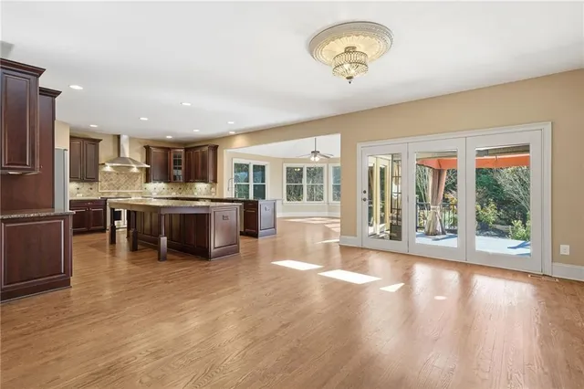 a bathroom with a granite countertop sink and a toilet