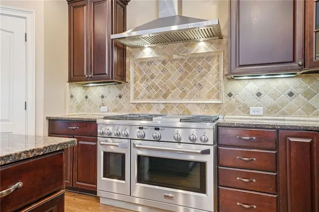 a bathroom with a granite countertop sink toilet and mirror
