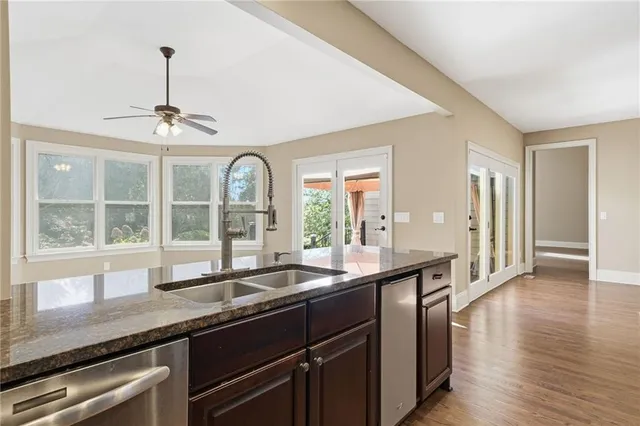 a bathroom with a granite countertop toilet sink and mirror