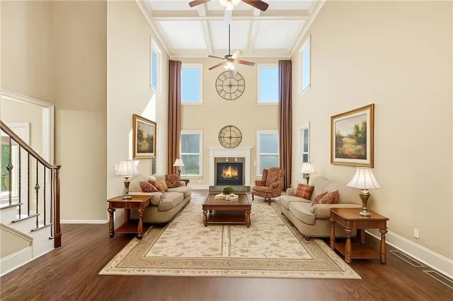 a living room with furniture a rug and a window