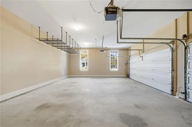 a view of an empty room with wooden floor and a fireplace