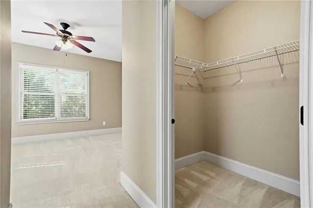 an aerial view of a house with a yard and trees