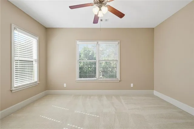 a view of a big house with a big yard plants and large trees