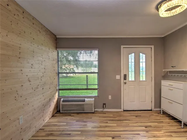 a view of a kitchen with furniture wooden floor and windows