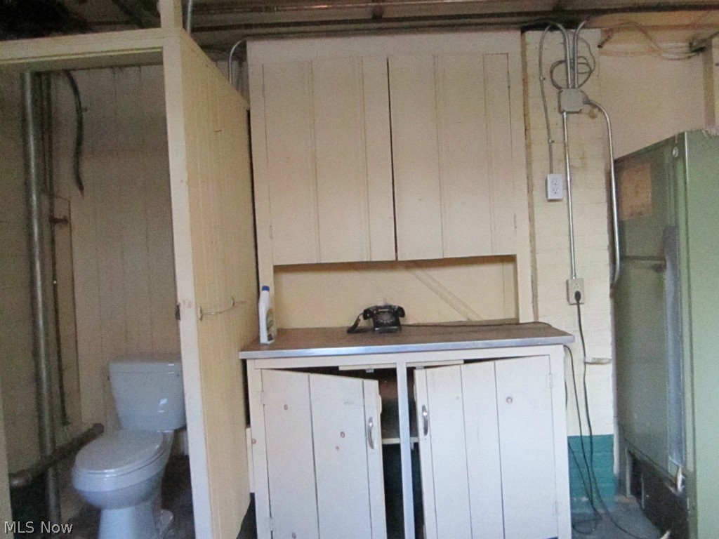 233 East Schaaf Road Independence, OH 44131 - Photo 18 of 22 Large 13x13 laundry room has storage cabinets and a newer commode.