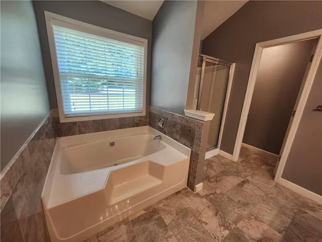 a bath tub sitting in a bathroom next to a window