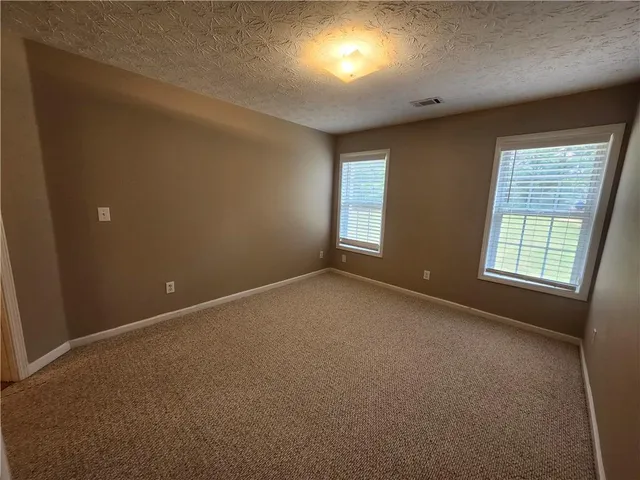 a view of an empty room and closet area