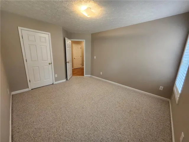 an empty room with closet area