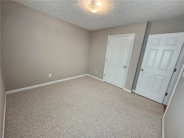 a white toilet sitting next to a shower