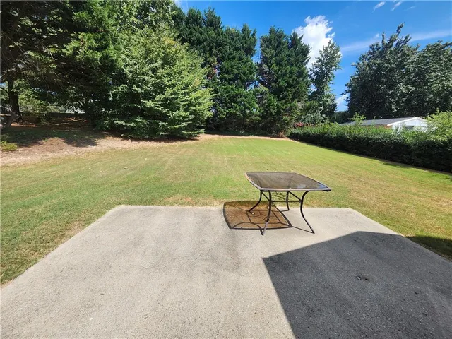 a front view of a house with a garden and yard