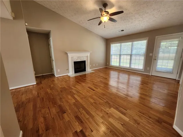 wooden floor in an empty room with a fireplace