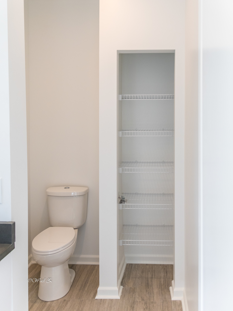 12728 Wild Rye Court, Unit B Plainfield, IL 60585 - Photo 20 of 21 a bathroom with a toilet and a vanity