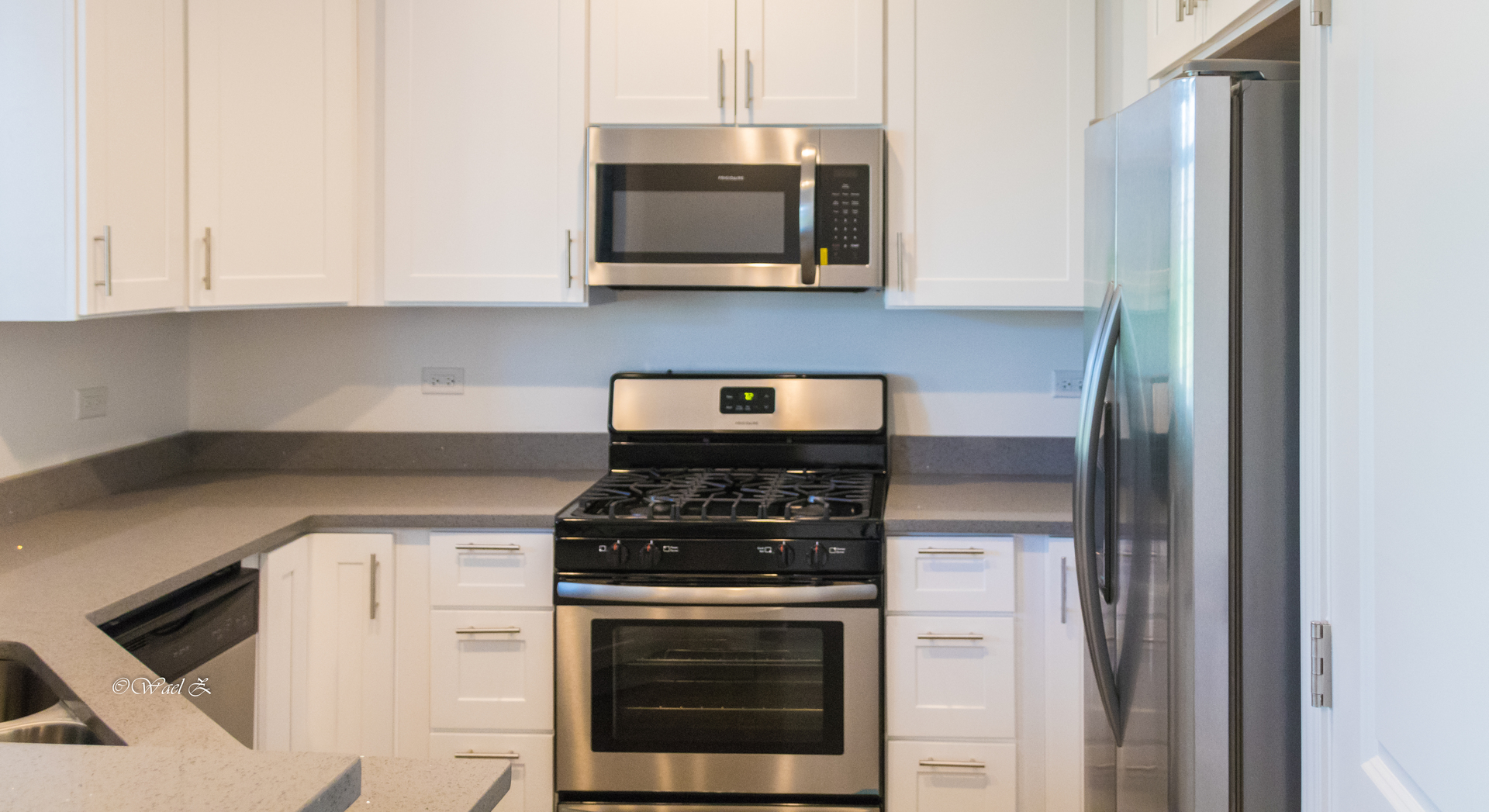 12728 Wild Rye Court, Unit B Plainfield, IL 60585 - Photo 7 of 21 a kitchen with stainless steel appliances granite countertop white cabinets and black stove top oven with granite countertops