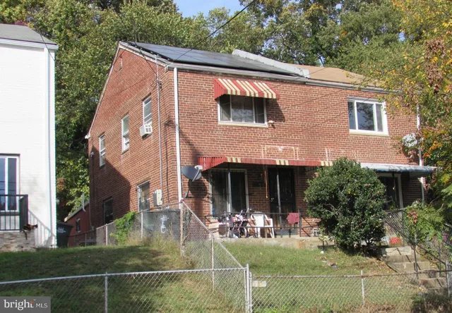 a view of house with outdoor space and sitting area