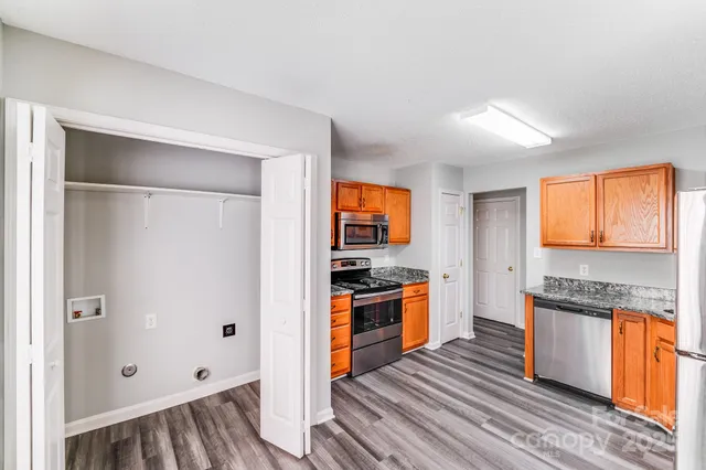 a kitchen with stainless steel appliances granite countertop a refrigerator and a sink
